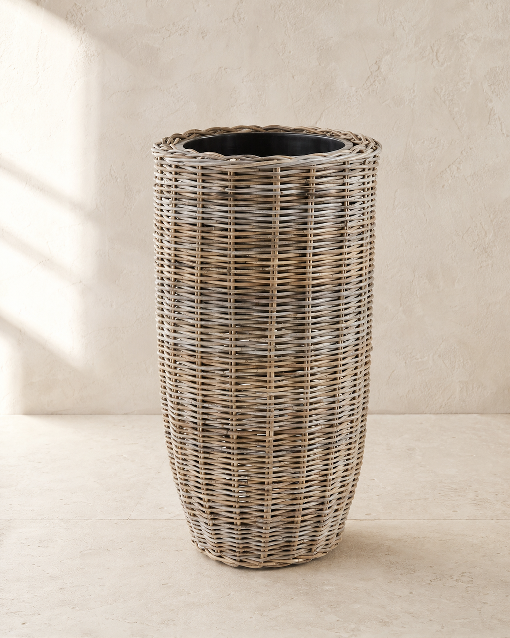 Diego Handwoven Rattan Planter in warm architectural studio light