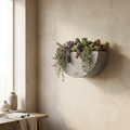Ostra Wall Half-Round cast concrete wall planter in natural grey with cascading sedum