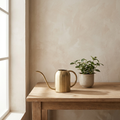 Verdant Brass Watering Can brushed brass watering can with long spout on oak potting bench