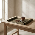 Waxed Canvas Potting Mat in olive with terracotta pot and soil scoop on oak table