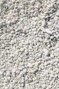 Polished white pebbles close-up on neutral background