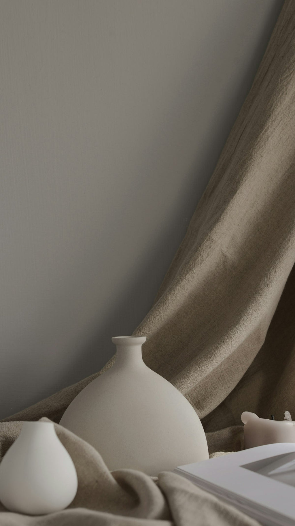 Minimal ceramic vase with dried botanicals on neutral surface