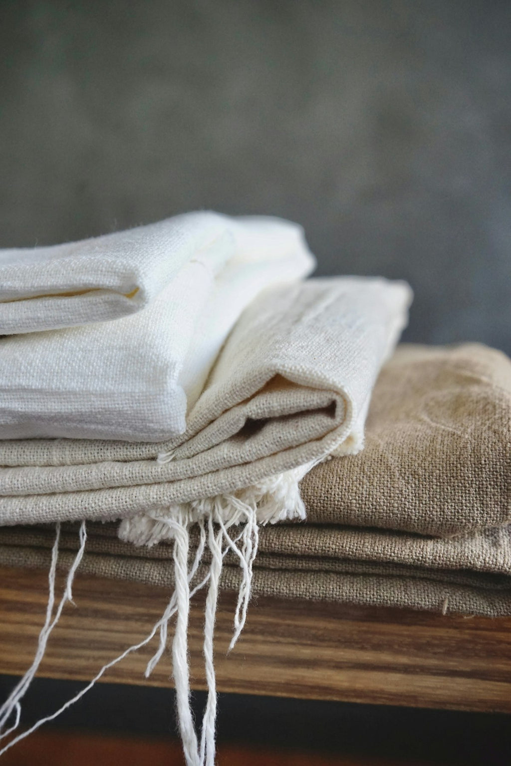 Soft linen throw in warm neutral tone on minimalist sofa