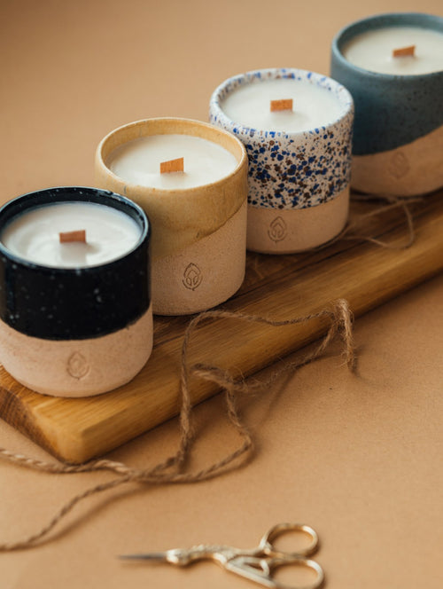 Minimal soy candle in ceramic vessel with warm ambient light