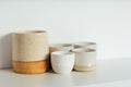 Matte ceramic bowl in warm sand color on styled surface