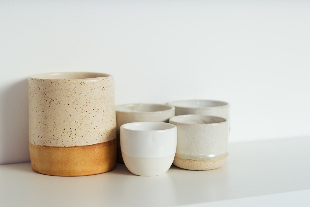Matte ceramic bowl in warm sand color on styled surface