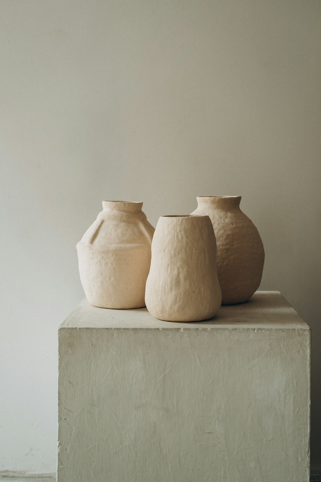 Set of three ceramic bud vases in white and cream tones