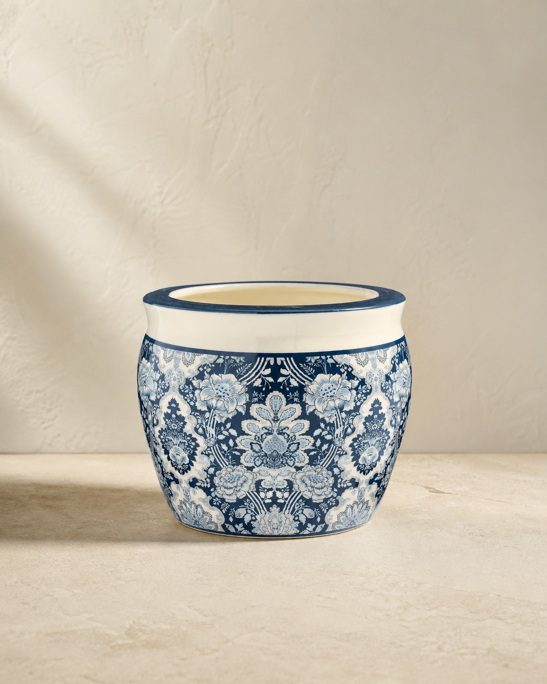 Blue-and-white floral Arboretum cachepot on pale limestone.