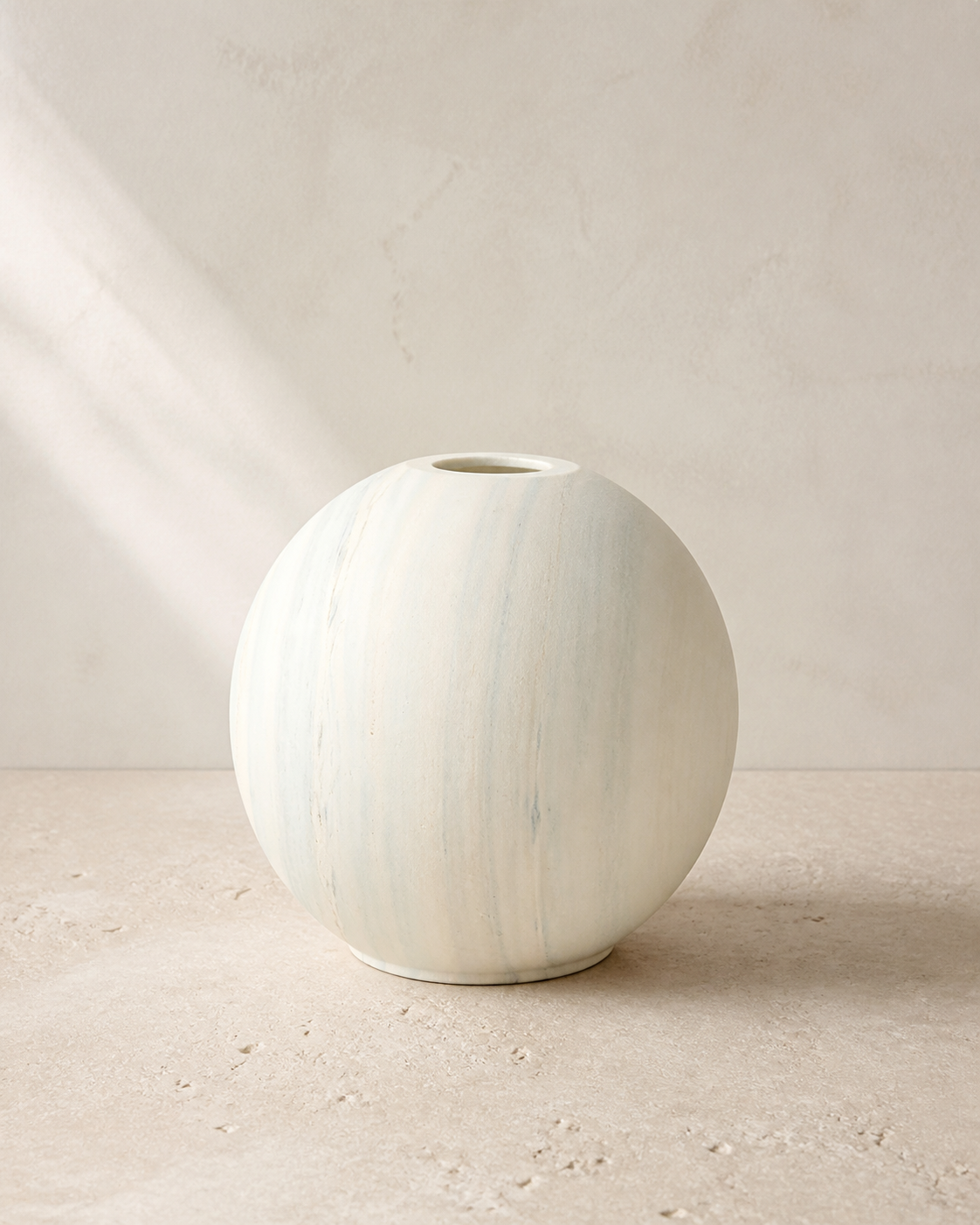 Artesian off-white sandstone vase in warm natural light.