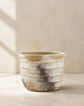 Weathered hand-painted terracotta outdoor planter with a layered neutral finish.