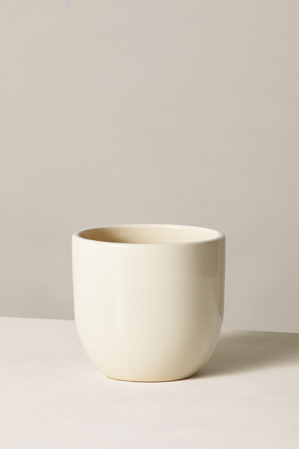 White ceramic cup on a light gray background