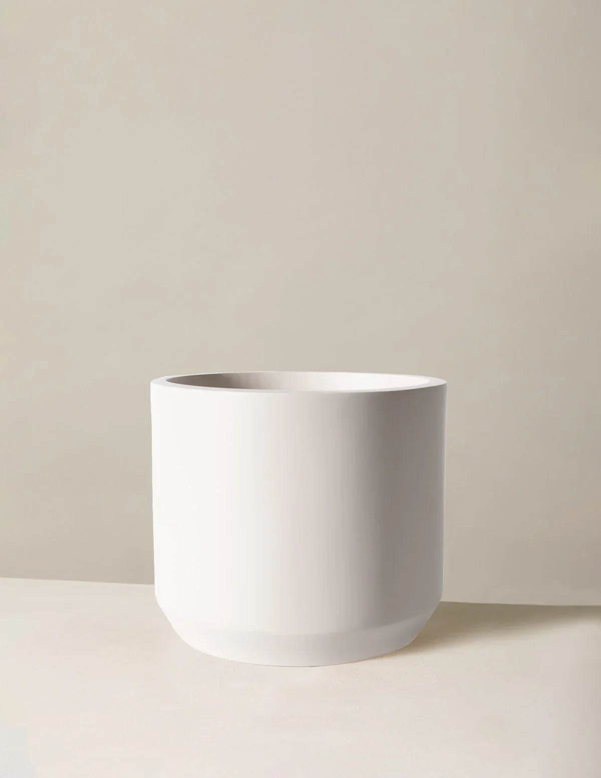 White ceramic pot on a beige background