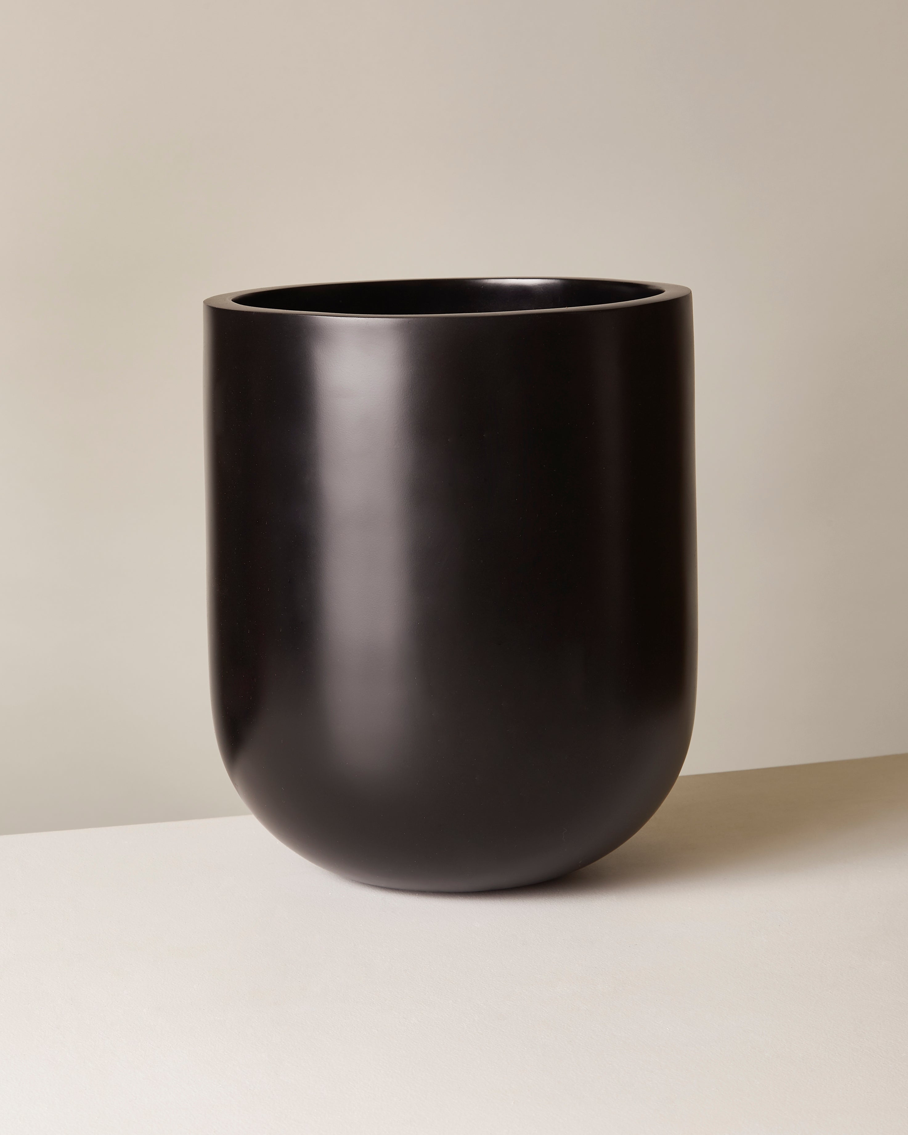 Black vase on a beige background